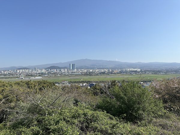 도두봉에서 내려다본 공항 활주로 너머 제주 시내와 먼 산